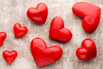 Red hearts on the wooden background.
