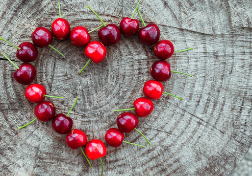 Heart made of cherries. Vegan eating concept. 