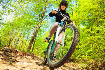 Fototapeta na wymiar Young Woman Riding Her Mountain Bike