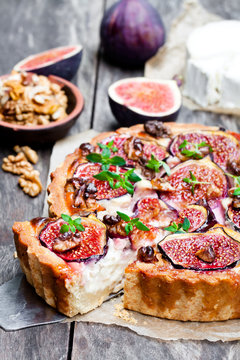 Delicious  tart with fresh figs and goat cheese on rustic wooden