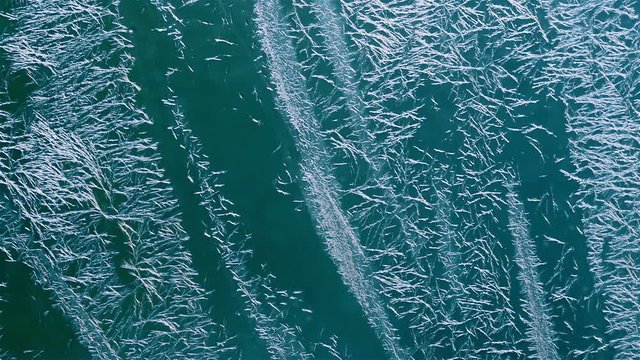 Frost forms on a window against a cyan background