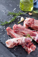 Raw meat on the bone with olive oil, fresh herbs and spices. Hea