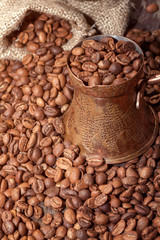 Turkish Coffee beans in copper pot .