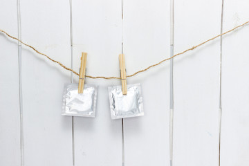 close up of a condom and  clothes peg on white background with clipping path