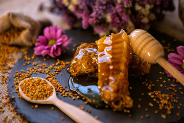 natural sweet honeycombs and pollen on table.