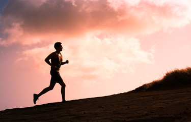 Fototapeta na wymiar Male runner running up a hill. 