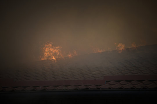 Fire and smoke on the burning roof