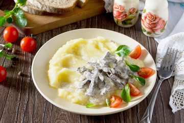 Traditional hot meat stew with sour cream and garnish mashed pot