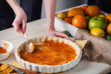production of cake with citrus marmalade and slices of mandarin