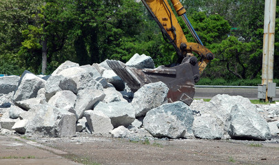Dredger construction at work, parses the obstruction from the rocks with grab