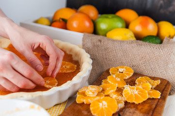 production of cake with citrus marmalade and slices of mandarin