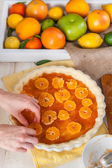 production of cake with citrus marmalade and slices of mandarin