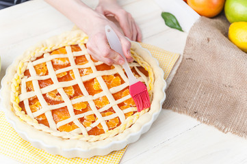 production of cake with citrus marmalade and slices of mandarin