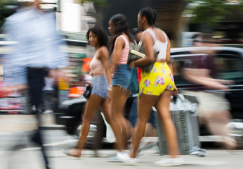 Group of young girls in Oxford street, London.  Blurred image. 