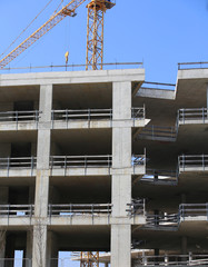 yellow crane and the huge residential and commercial building un