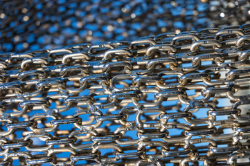 Abstract metal chain links on blue background
