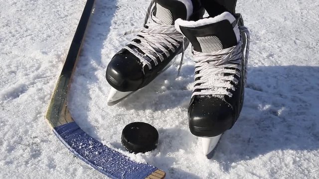 Close-up on hockey puck and hockey equipment