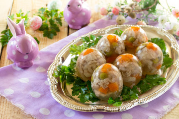 Easter treats: Easter Jellied eggs on a wooden table, jelly meat