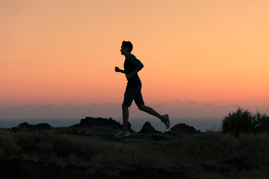 Silhouette of man running early morning. 
