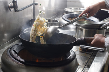 Close up of working chef preparing chinese food