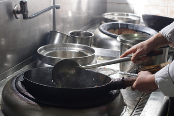 Close up of working chef preparing chinese food