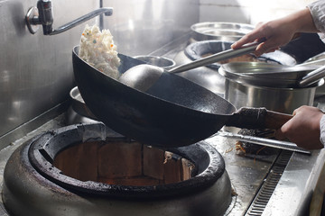 Close up of working chef preparing chinese food