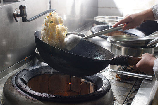 Close up of working chef preparing chinese food