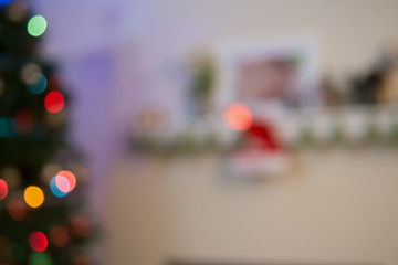 blurry bokeh light from Christmas tree and fire place for backgr