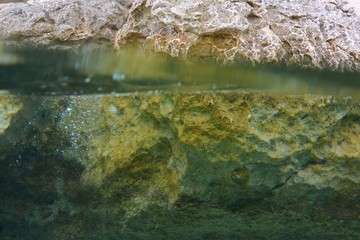 Stones over and under water.