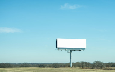 a blank billboard on highway with clear bluesky background