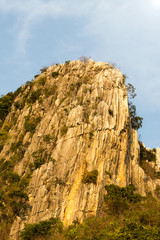 Fototapeta premium Mountain rock cliff with timber.