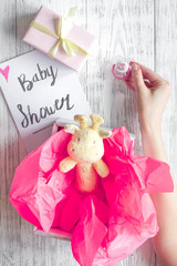 birth of girl - baby shower concept on wooden background