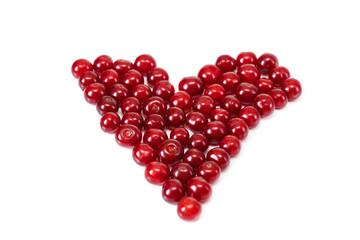 Heart from red fresh cherry.White isolated background.Fruit summer vitamins.