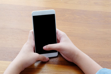 Hand holding smartphone with blank on screen background