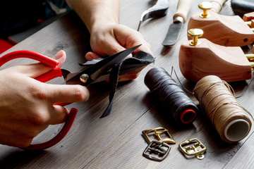 cobbler tools in workshop dark background close up
