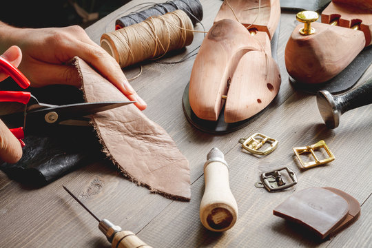 cobbler tools in workshop dark background close up