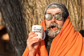 Man in blanket with cup