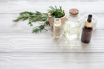 Naklejka na ściany i meble organic cosmetics with extracts of herbs rosemary on wooden background