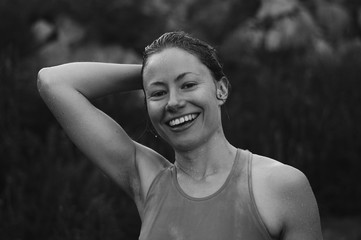 Black and white portrait of woman holding hair after swim