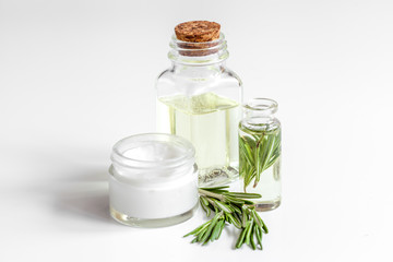 organic cosmetics with extracts of herbs rosemary on white background