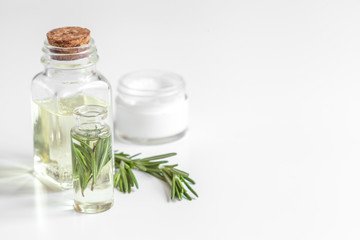 organic cosmetics with extracts of herbs rosemary on white background