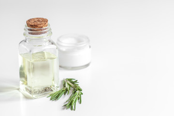 organic cosmetics with extracts of herbs rosemary on white background