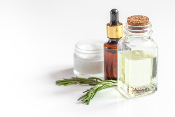 organic cosmetics with extracts of herbs rosemary on white background