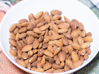 Pile of almonds in the white bowl