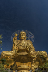 Gold statue of sitting Buddha