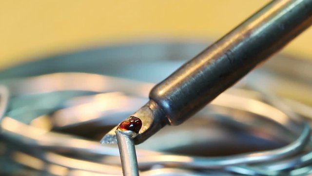 Melting solder wire on soldering iron tip