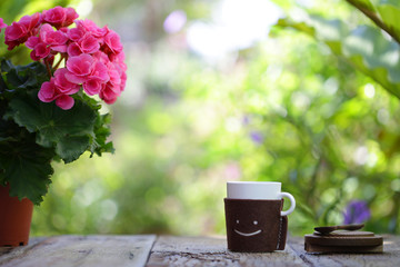 Smiling cup with flower pot