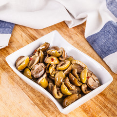 green olives bowl on wooden board