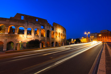 Fototapeta na wymiar Colosseum and traffic light trails at twilight in Rome