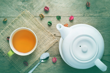 White tea pot ceramic and green tea cup on wooden table. Ceramic